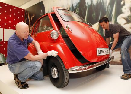  Die Isetta wird angeliefert und auf dem Podest aufgestellt.